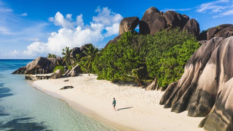 Man Walking On La Digue Beach